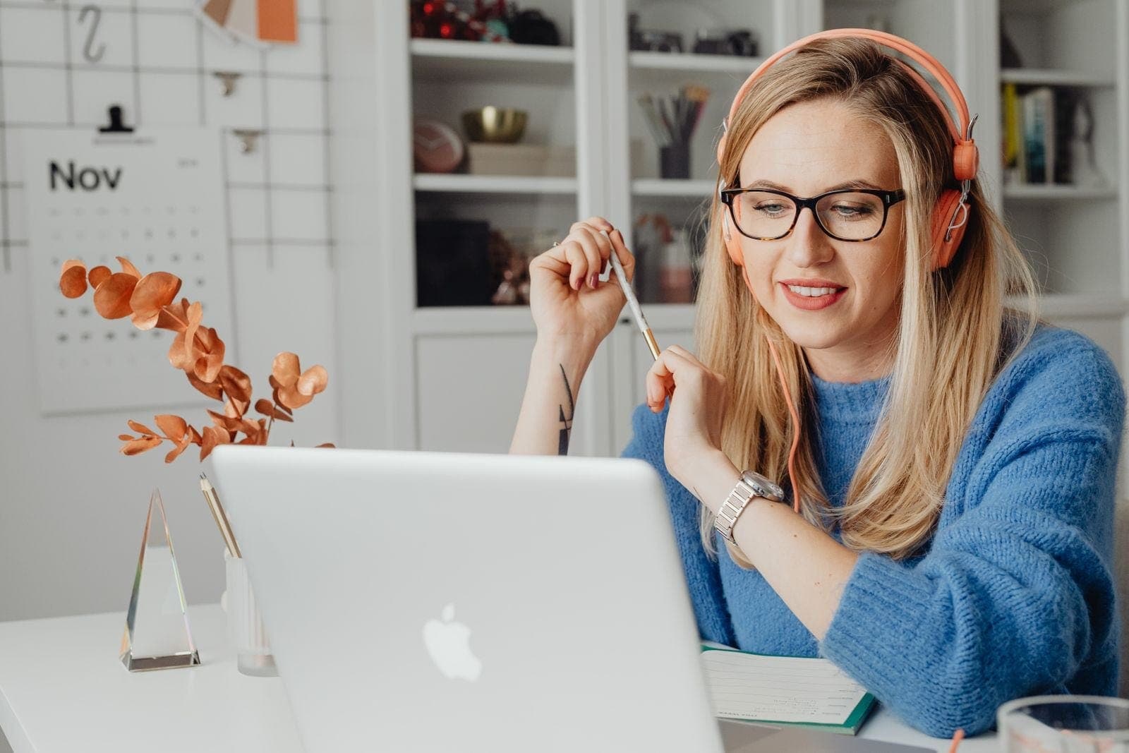Woman Using Laptop with Headphones on