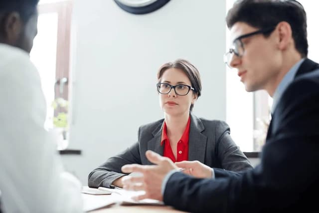 Professionals listening attentively during an interview conversation